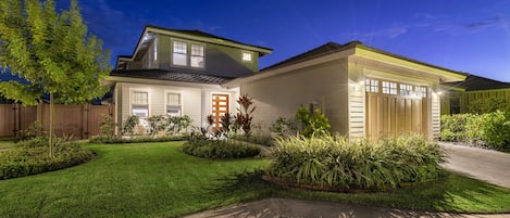 The front exterior of this Kona Hawai'i vacation rental as seen at night.