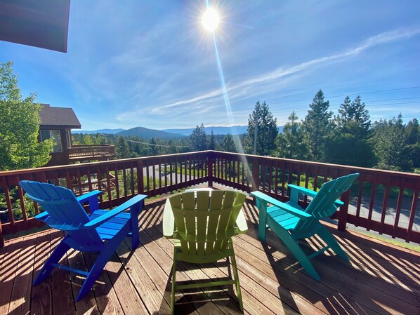 Deck with sunrise view, 3 Adirondack chairs, table, umbrella, and gas BBQ.