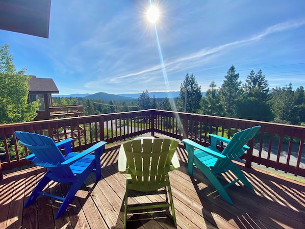 Deck with sunrise view, 3 Adirondack chairs, table, umbrella, and gas BBQ.