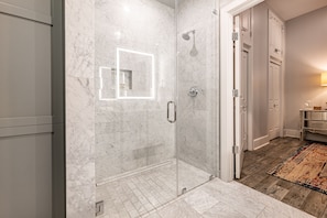 Ensuite Master Bathroom featuring a large frameless glass Italian marble shower. Enjoy the plush white towels, standard size blow dryer and complimentary travel size shampoo, conditioner, body wash, tooth brushes (2), tooth paste, mouth wash, lotion and makeup remover wipes (3).