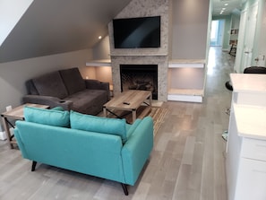 Living Room with gas log fireplace and large smart TV