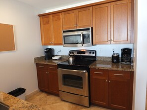 Full size kitchen with all small appliances and kitchenware.