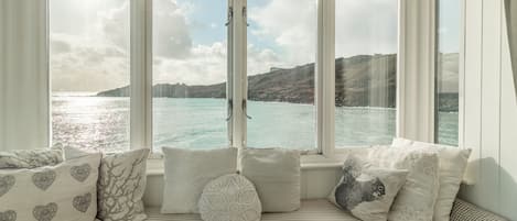 The Watch House, Coverack. First floor: Master bedroom, relax in a bay window overlooking the sea