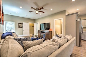 Living room with large sectional and cabinet electric fireplace