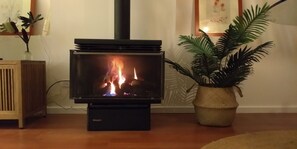 Cosy gas log fireplace keeps the place snug.