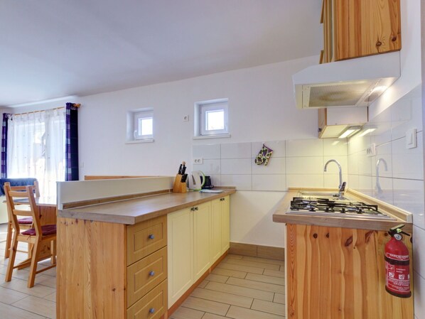 Kitchen, Countertop, Interior Design, Flooring, Wood, Ceiling, Furniture, Cabinetry, Floor, Kitchen Appliance
