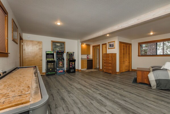 Full Size Shuffle Board Table, (3) Classic Arcades, and Wet Bar