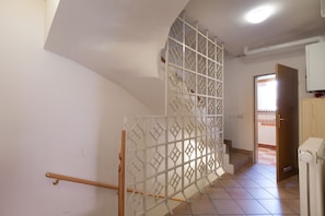 Apartment hallway; stairs leading to the 2nd bedroom with 2 single beds