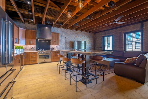 Large combined kitchen and living with bar seating.