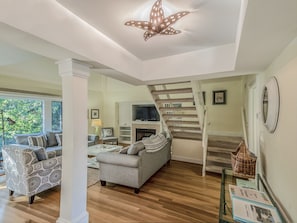 Gather around the gas log fireplace or watch TV on the large screen.