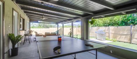 Ping pong table, covered patio, bbq, patio furniture, dining table and bar top.