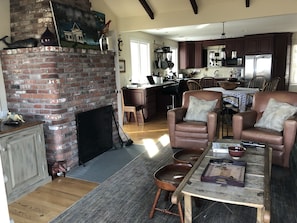 Living room, dining area and kitchen.  The fireplace is wood burning.