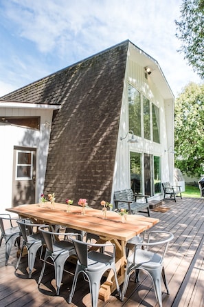 Enjoy dinners al fresco on this hand made farm table and large deck overlooking the lake surrounded by trees.