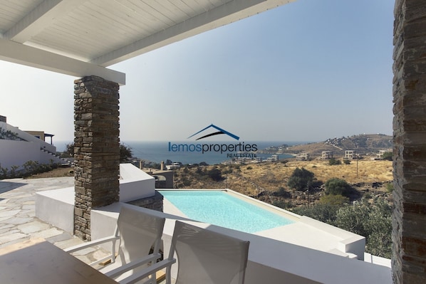 The front veranda with a sew view and a view of the swimming pool