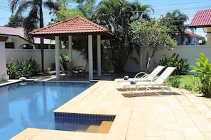 The private pool, complete with sunbeds and outside sala