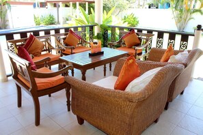 Outside terrace with ample seating, overlooking the swimming pool