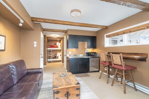 The living area is great for relaxing and offers  a flat screen TV , and bar seating for two.