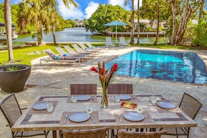 Enjoy outdoor grilling and dining with seating for six, while taking in views of the heated pool and the waterway.