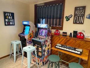 Arcades and kids piano in amazing entertaining basement theater room