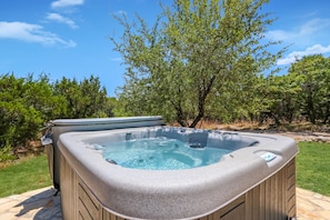 Private hot tub in the backyard surrounded by local nature