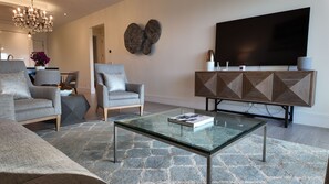 Living room with Samsung smart TV and Bang & Olufsen stereo speaker.