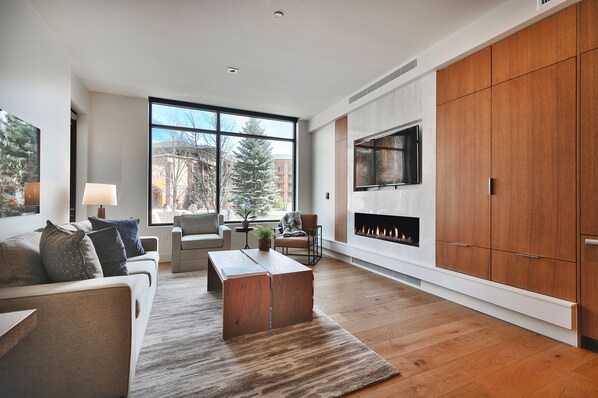 Elegant living room with feature fireplace wall and large flat screen TV