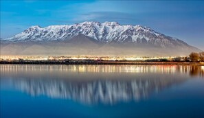 View at dusk looking across Utah Lake at the snow-capped Mt. Timpanogos