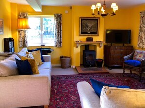 Cosy living room with wood burner | Orchard House, Hempstead, near Holt