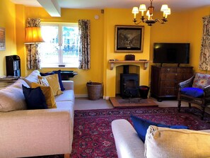 Cosy living room with wood burner | Orchard House, Hempstead, near Holt