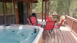 Hot tub located on covered back deck.