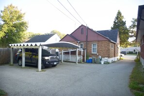 parking for 2 vehicles one under the roof and the second to the left of the roof