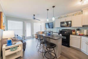 Kitchen and living space lead to balcony overlooking the Gulf of Mexico.