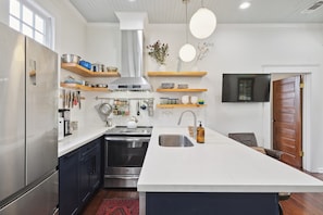 Kitchen, well stocked with everything you need to prepare a meal during your stay: Ninja blender and coffee maker (with coffee and sugar), stainless steel cookware, dutch oven, kettle, basics