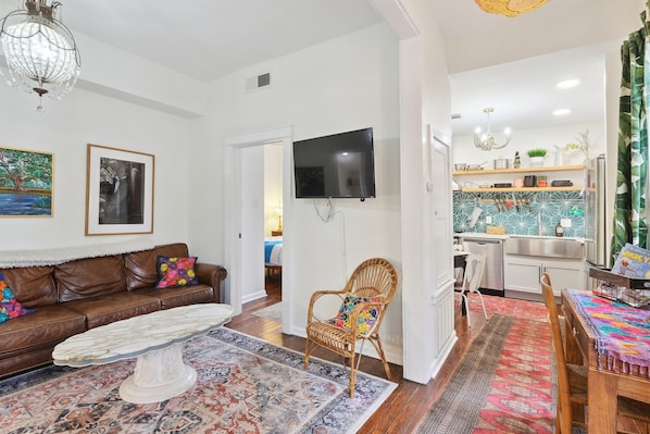 Entry way with living room to left and kitchen to right