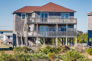 Relieve your stress and focus on the fun in this 5-bedroom oceanfront home — filled with playful amenities!
