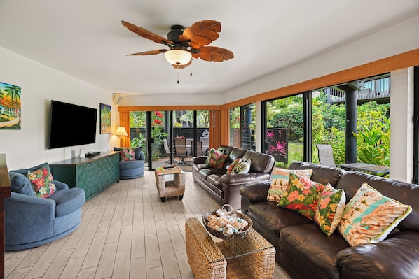 Expansive living area with three slider doors and large windows for an open feel.
