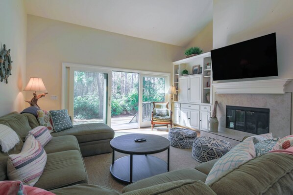 Sailors Cove features this comfortable living room with access to the back patio & private pool.