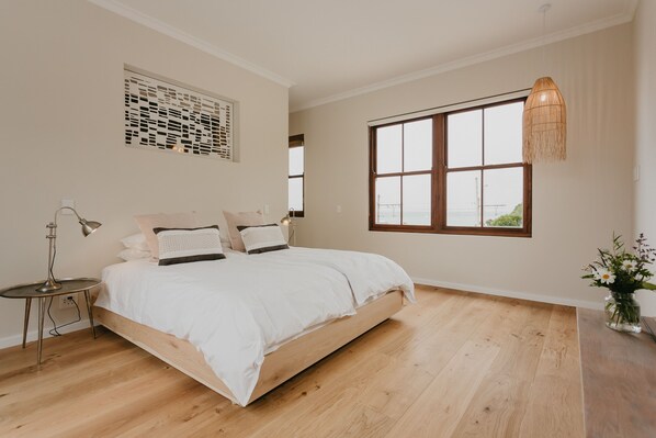 Main bedroom with on-suite bathroom with bath tub. King size bed, extra length.