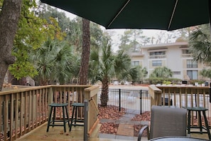 Relax on the deck and enjoy the view of the pool and natural landscaping 