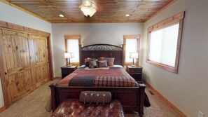 The master bedroom is located on the main floor with a King bed and large window to enjoy the beautiful surroundings.