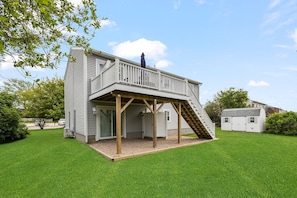 Back Side of House with Deck, outdoor shower and patio area.