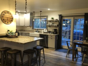 Open kitchen with island seating or dining table seating.