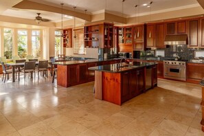 Enjoy modern lighting and granite counter tops in this beautiful kitchen.