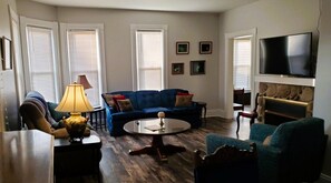 Livingroom with 50-inch TV and fireplace.