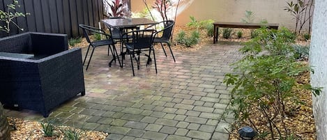 Beautifully landscaped private patio with seating and dining