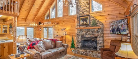 Antler Chandeliers, Vaulted Ceilings with Exposed Beams,  and Wood Floors in Open Concept Main Level