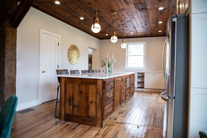 Rustic modern kitchen with out custom-made island made out of original barn wood