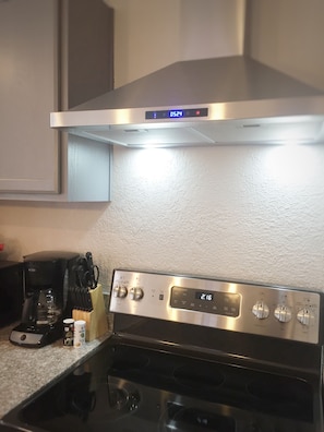 Full size electric range with oven and outside vented hood