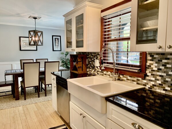 Fully-stocked kitchen with cookware, dinnerware, coffee maker, blender, and more