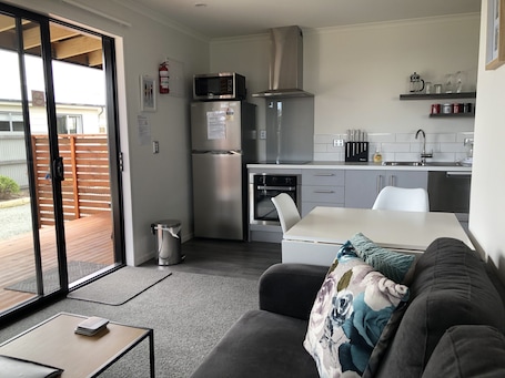 Open plan living / dining and kitchen area opening onto the north facing deck